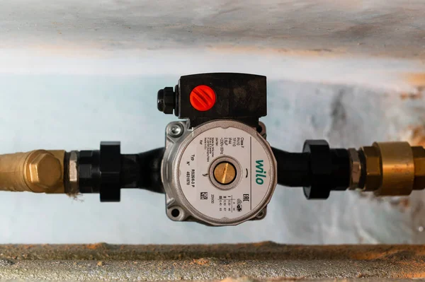 Dolyna, Ukraine March 24, 2021: installation of a wilo water pump in the heating system, home heating.