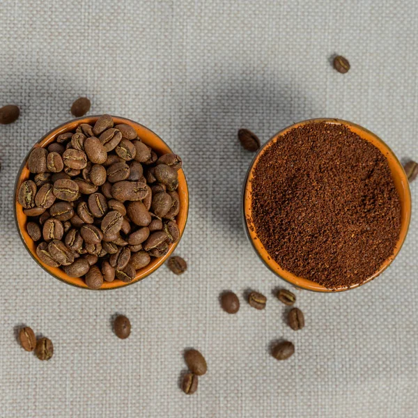 Ground and whole-grain coffee on a light background, top view of coffee, copy space.