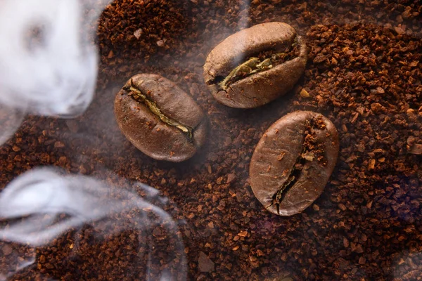 Ground coffee and coffee beans, lightly smoked coffee, coffee texture and copy space.