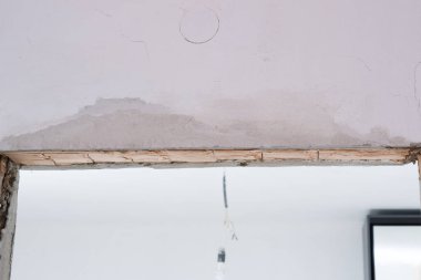 Wooden doorway, replacement and reconstruction of the old door in the room, wooden walls.