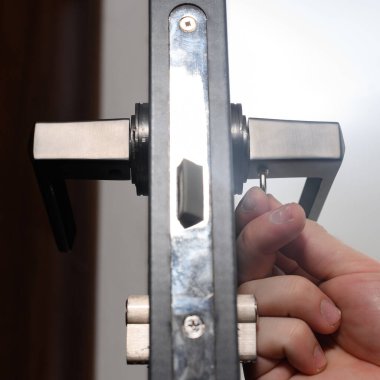 Hex key and installation of door lock and handle, close-up installation work, interior door.