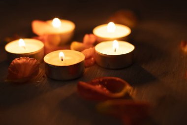 Rose petals and scented candle set, romantic evening, five candles and flower petals.