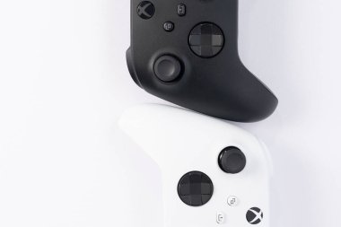 Ivano-Frankivsk, Ukraine August 14, 2022: x series gamepad on a white background, black and white gamepads for games.