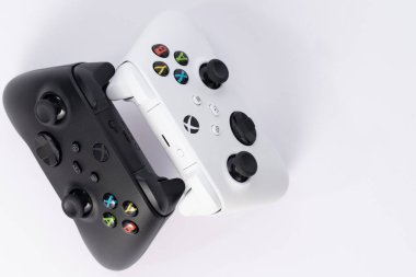 Ivano-Frankivsk, Ukraine August 14, 2022: x series gamepad on a white background, black and white gamepads for games.