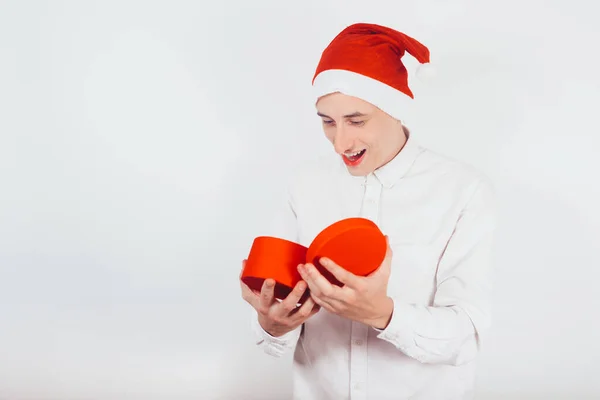 Guy Santa Hat New Year Holding Gift His Hands Red — Stock Photo, Image