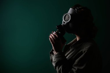 Gaz maskeli bir askerin fotoğrafı, kıyamet, nükleer silahlar, bir istasyonun atom patlaması, kimyasal ve nükleer silah koruması. Yeşil arka planda maskeli bir kız, savaş