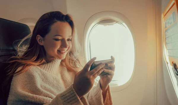 Een Mooi Meisje Zit Een Vliegtuig Naar Telefoon Kijken Een — Stockfoto