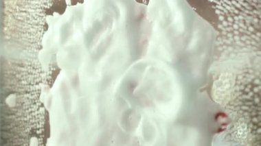 Glass cleaner splashes on a mirror on which there is an inscription with lipstick. Cleaning
