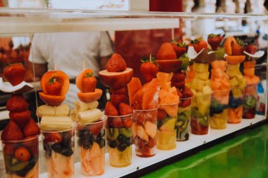 Fruit diet, fruits in a cup, strawberries, coconut and pineapples with kiwi. Italian snack. Healthy lifestyle