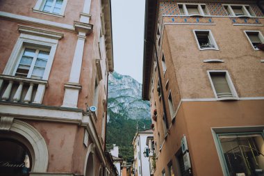 Italy. Trentino 07/09/2022 Riva del Garda. Houses and architecture of the city against the backdrop of mountains. Beauty and vacation, summer day, travel. Card
