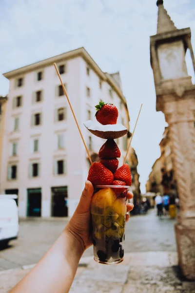 Fruit diet, fruits in a cup, strawberries, coconut and pineapples with kiwi. Italian snack. Healthy lifestyle