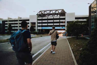 Italy. Venice. 09.07.2022 A group of people walk towards the parking lot against the backdrop of a sunset in Venice. Traveling with friends tourists