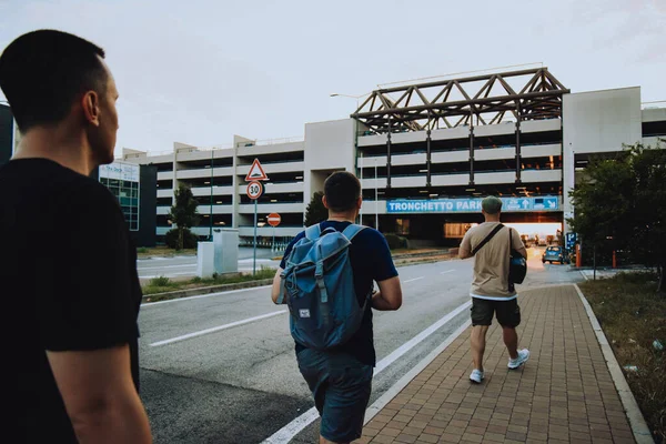 Italy. Venice. 09.07.2022 A group of people walk towards the parking lot against the backdrop of a sunset in Venice. Traveling with friends tourists