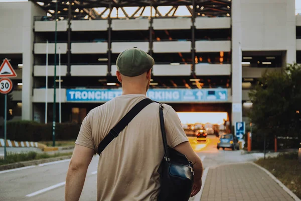 Italy. Venice. 09.07.2022 A man in a parking lot with the sunset in the background goes to the car. atmospheric photo