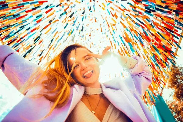 Gorgeous girl dances at the festival. Young woman rejoices and has fun. Style and fashion