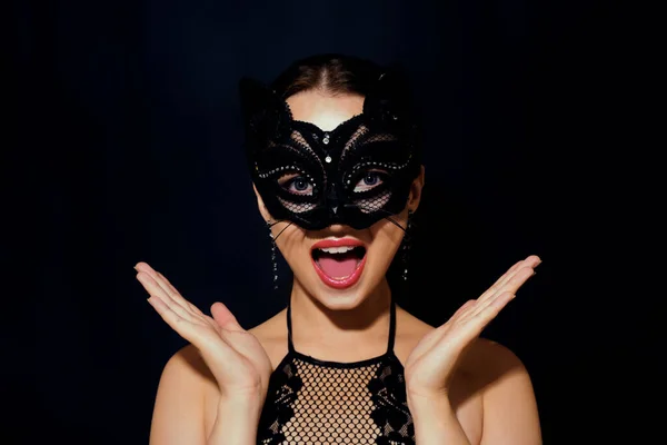 The girl in the mask. Masquerade, halloween. Girl in a cat mask. Catwoman on a beautiful background in a beautiful lace top with long earrings