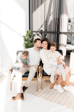 Genç ve mutlu bir aile. Erkek kadını öpüyor  