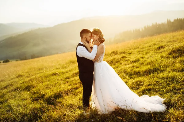 美しい若い結婚式のカップルが山を背景にポーズをとって — ストック写真