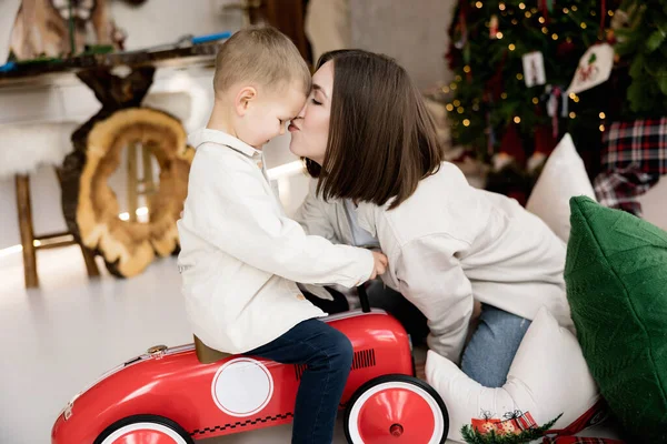 Mother Kisses Her Little Son Sitting Toy Car — Photo