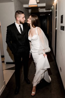 beautiful bride and groom posing in the hallway