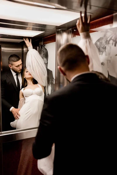 bride and groom posing in the lift