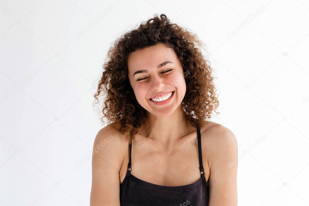beautiful curly girl laughing on a white background