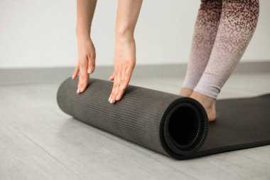 Girl rolling out a yoga mat