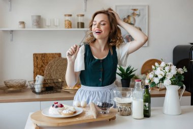 Pretty girl cooking in the kitchen. High quality photo