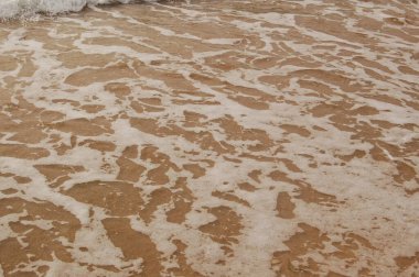 Denizin yüzeyi kumsalda, dalgalar arka plan olarak ya da duvar kağıdı olarak.