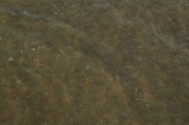 Denizin yüzeyi kumsalda, dalgalar arka plan olarak ya da duvar kağıdı olarak.