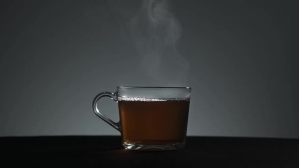Ångan kommer från en genomskinlig mugg te — Stockvideo