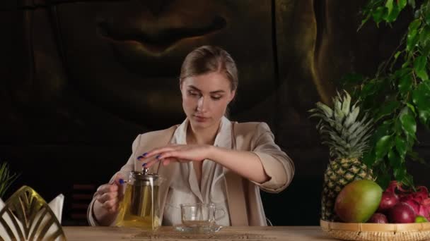 The girl pours herself fragrant tea — Stock Video