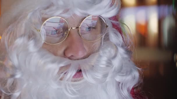 Santa Claus using digital citylight board, close up face Stock Footage