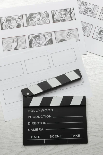 A storyboard of characters for the film and a clapperboard on the director\'s desk.