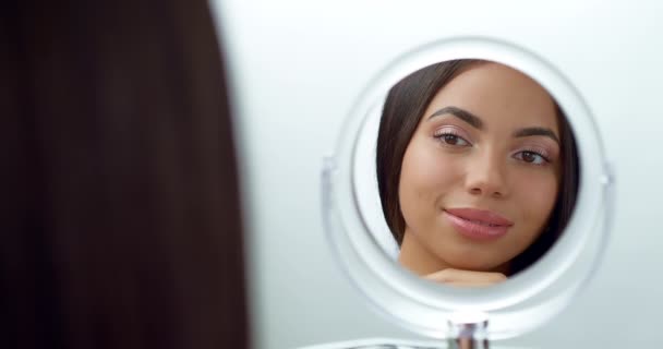 Beautiful African American Young Woman Looks Mirror Getting Ready Makeup — Stockvideo