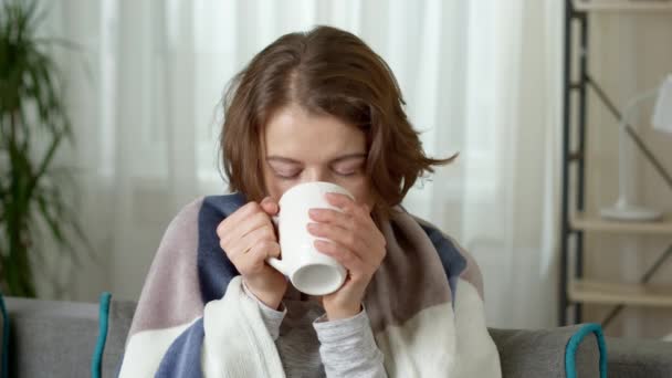 Cold Woman Temperature Treated While Drinking Tea While Sitting Home — Stock Video