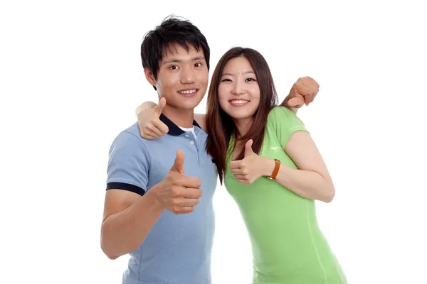 Joven sonriendo con los pulgares hacia arriba gesto — Foto de Stock