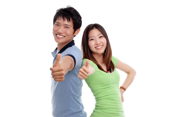 Joven sonriendo con los pulgares hacia arriba gesto — Foto de Stock