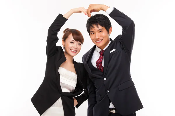 Business couple making heart symbol — Stock Photo, Image