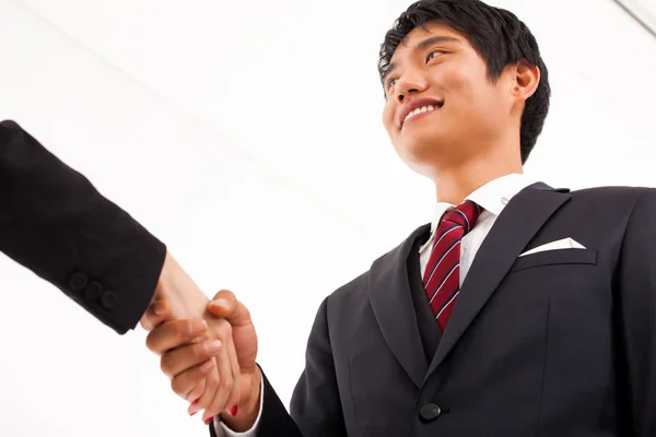 Shaking young Asian business man. — Stock Photo, Image