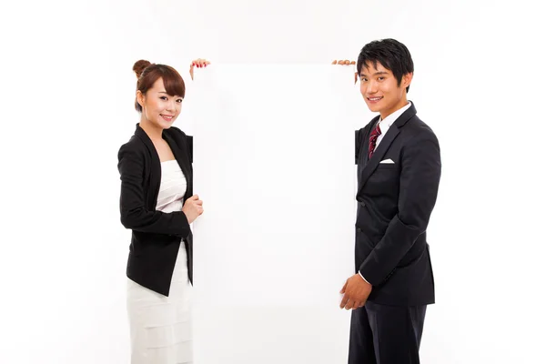 Business couple holding a add banner. — Stock Photo, Image