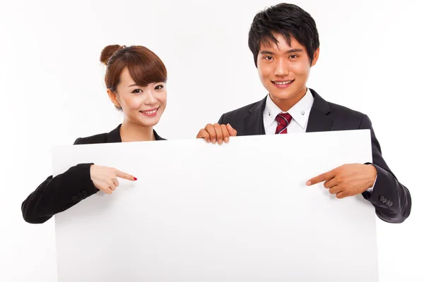 Business couple holding a add banner. — Stock Photo, Image