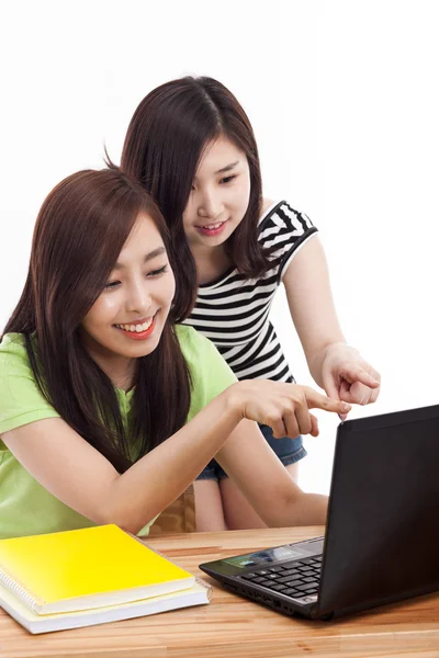 Two Asian young woman using computer on the desk Stock Picture
