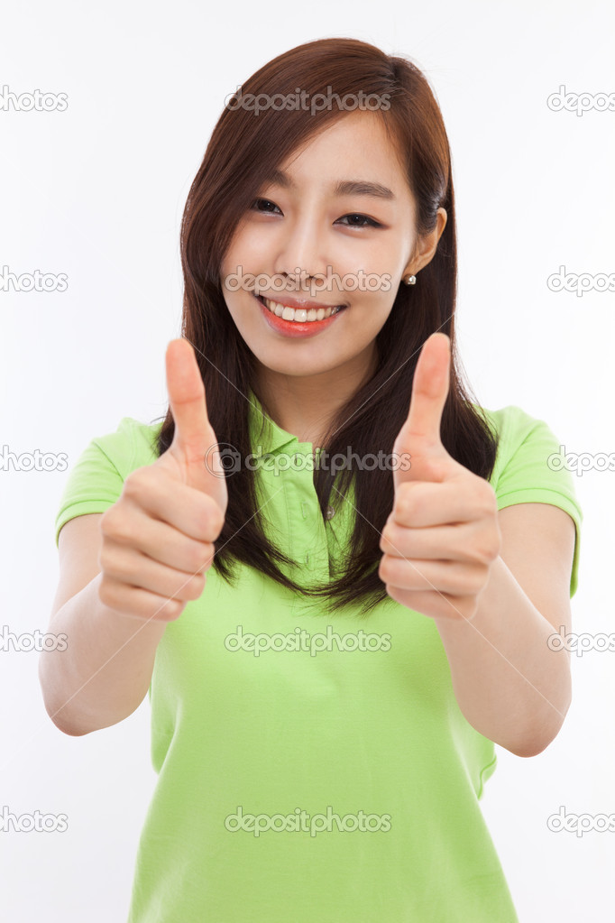 Young pretty Asian woman showing thumb.