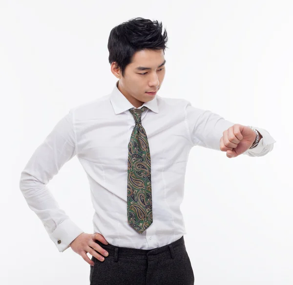 Young business man consulting his watch — Stock Photo, Image