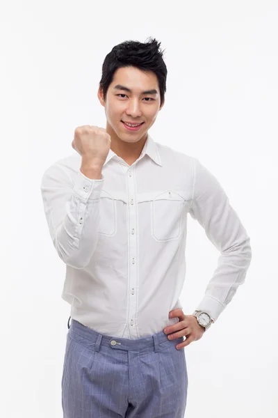 Jonge Aziatische man vuist en gelukkig teken weergegeven:. — Stockfoto