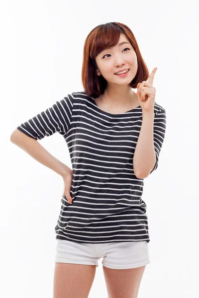 Smiling young woman pointing upwards — Stock Photo, Image