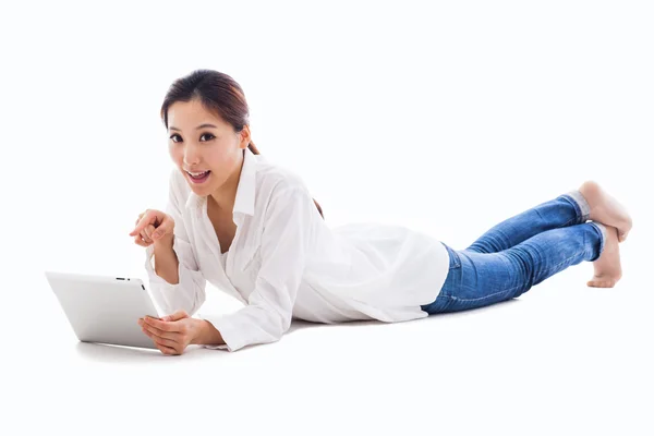 Asian woman lying down with tablet PC Stock Picture