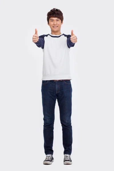 Showing thumb Asian young man — Stock Photo, Image