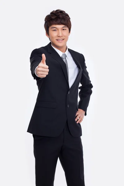 Showing thumb young Asian business man. — Stock Photo, Image